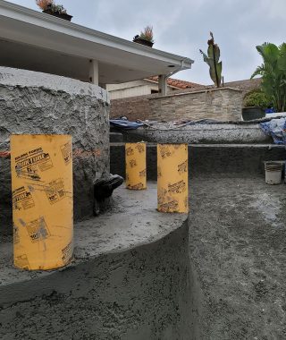 A man skillfully pours concrete into a pool