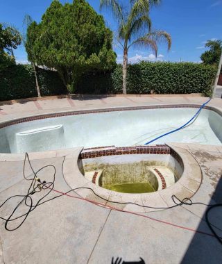 A pool being cleaned with a hose, showcasing the process of maintaining water clarity and hygiene.