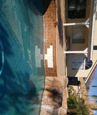 A serene pool surrounded by a rock wall