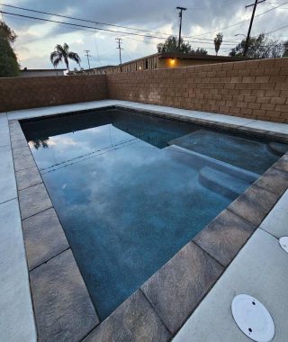 A concrete pool featuring a solid base and sturdy walls