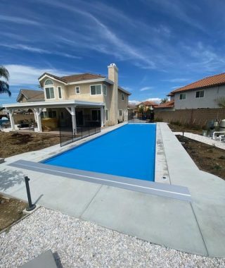 A pool covered with a blue tarp and a metal cover