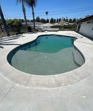 A beautiful swimming pool featuring a clear blue sky